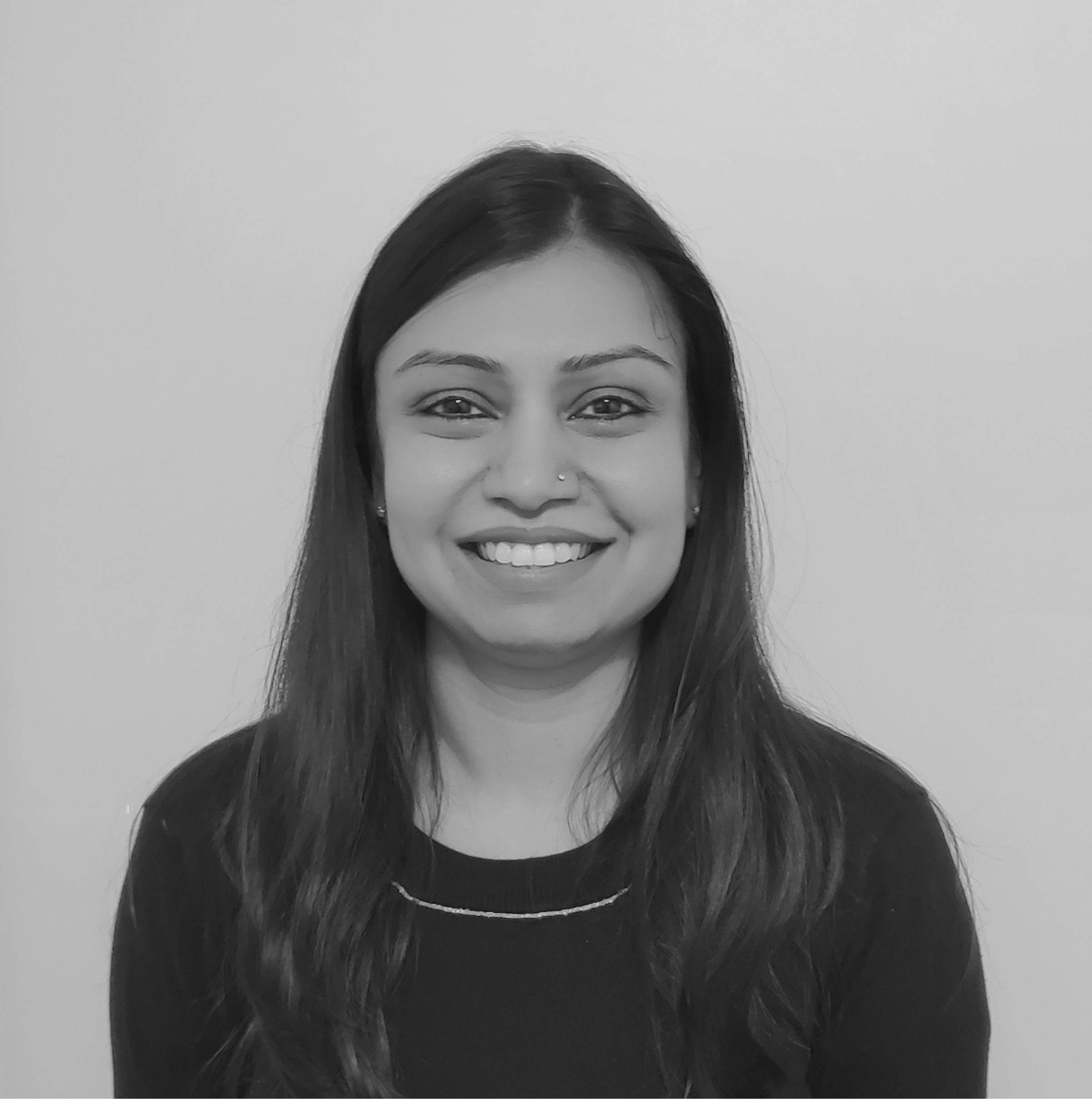Rachita Jain has a big smile on her face and long dark hair. Rachita is our Indian recruiter based in Toronto and the image of her is in black and white.