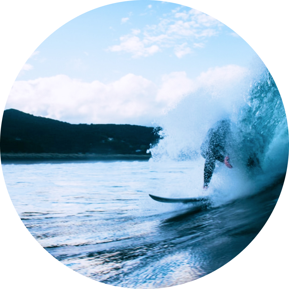 A surfer has water splashing in his face as he catches a wave. Brian Wiebe who got his start with a career in cloud computing is a surfer himself hence the name Groundswell Cloud Solutions